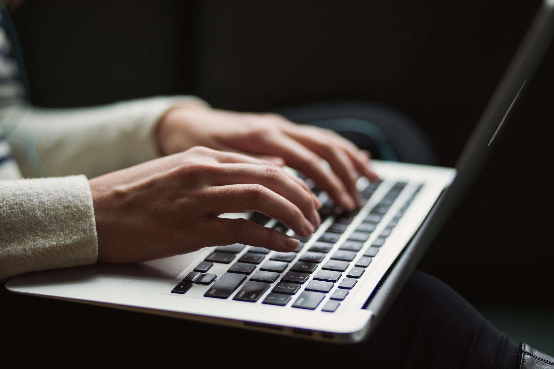 Hands typing on a keyboard.